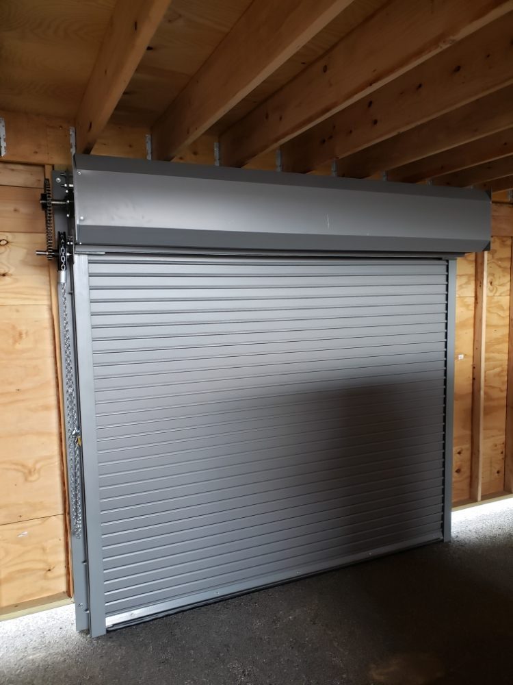 Rolling steel service door with chain hoist operator installed in a commercial building